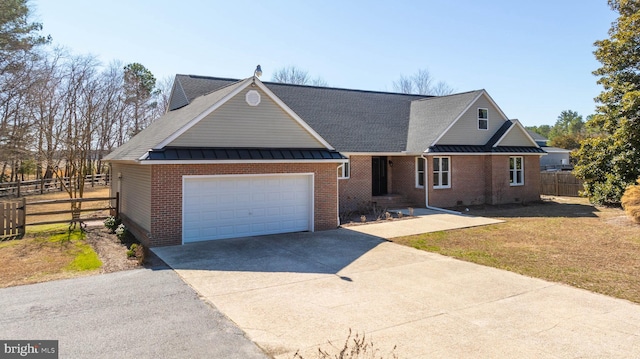 view of front of home featuring a standing seam roof, concrete driveway, brick siding, and metal roof