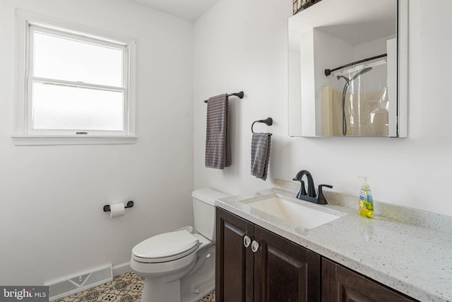 bathroom featuring vanity, a shower with curtain, visible vents, baseboards, and toilet