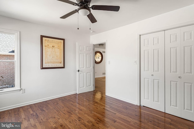 unfurnished bedroom featuring a closet, baseboards, and wood finished floors