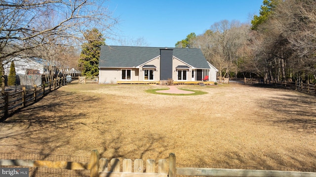 exterior space featuring a fenced backyard, roof with shingles, and a chimney