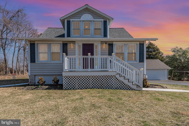 bungalow-style home with a porch, an outdoor structure, a front yard, and a shingled roof