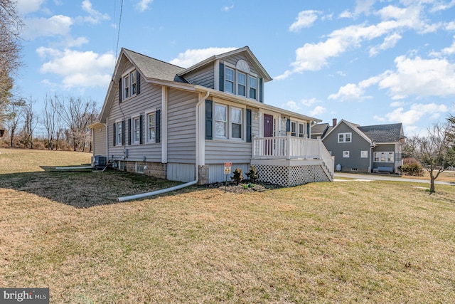 view of front facade with central AC and a front lawn