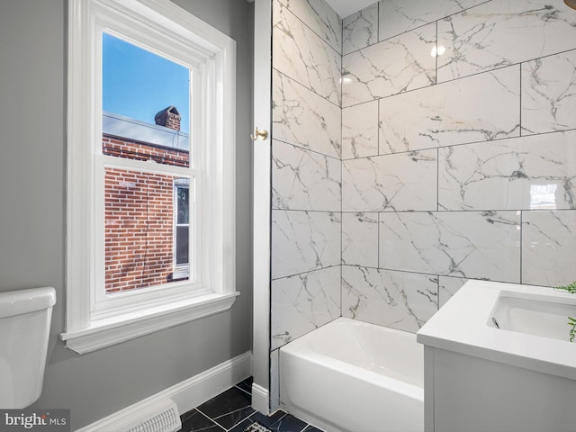 full bath featuring baseboards, toilet, bathtub / shower combination, marble finish floor, and vanity