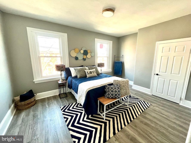 bedroom with baseboards and wood finished floors