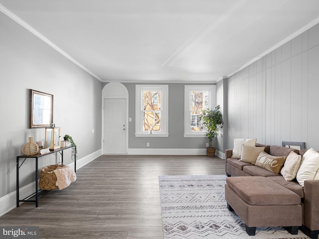 living area with crown molding, baseboards, and wood finished floors