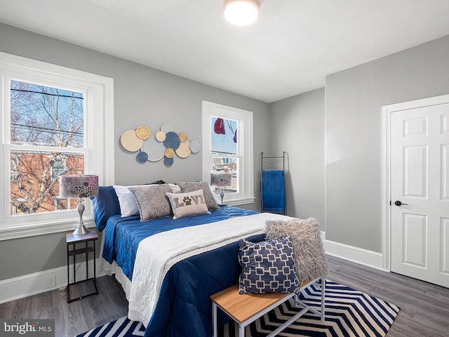 bedroom featuring baseboards and wood finished floors