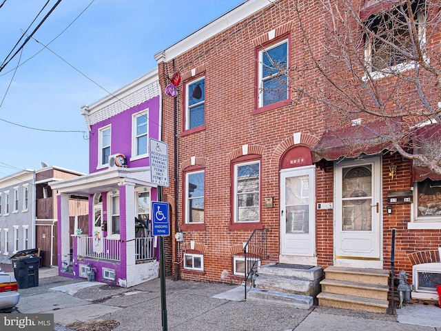 view of property featuring brick siding and entry steps