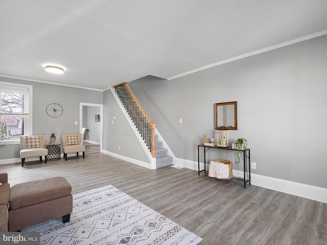 living room with stairway, baseboards, wood finished floors, and crown molding