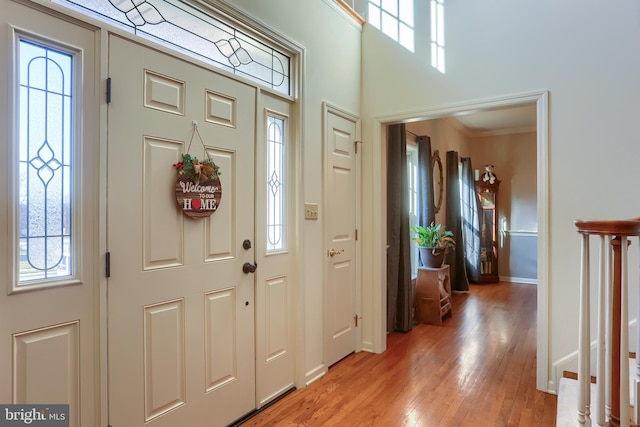 foyer entrance featuring light wood-style flooring and baseboards