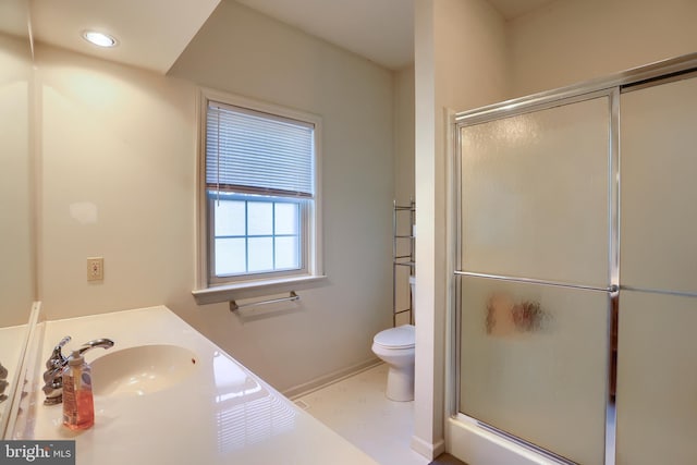 bathroom with vanity, a shower stall, toilet, and recessed lighting