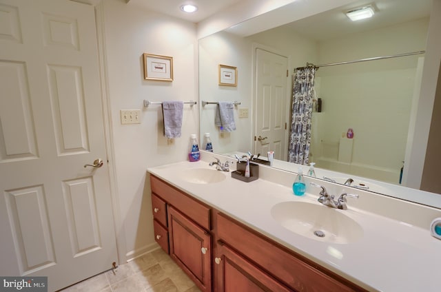 bathroom featuring a sink and double vanity