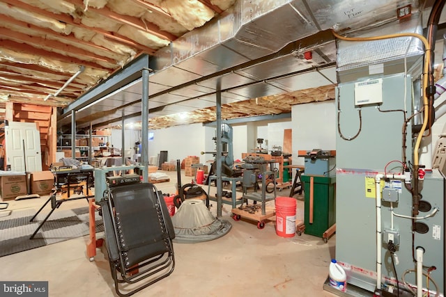 unfinished basement featuring heating unit