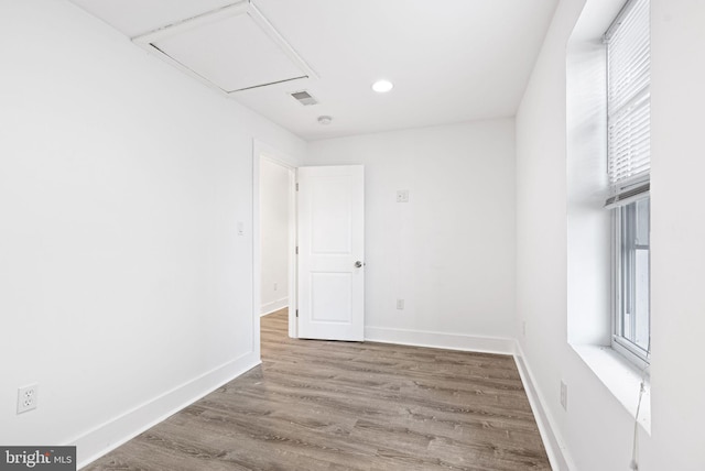 empty room featuring visible vents, recessed lighting, wood finished floors, and baseboards