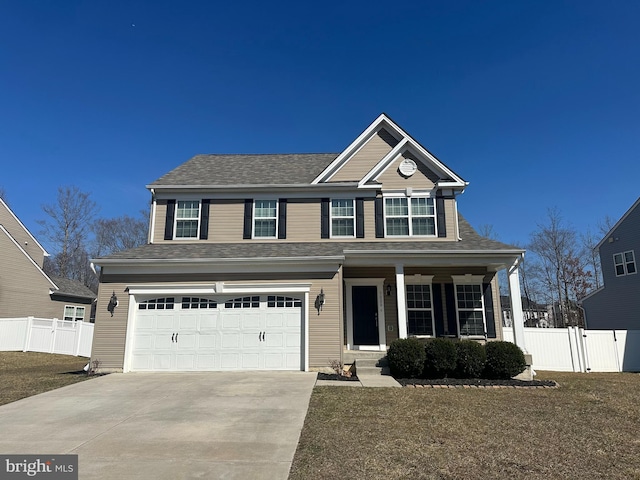 traditional home featuring a gate, covered porch, concrete driveway, and fence