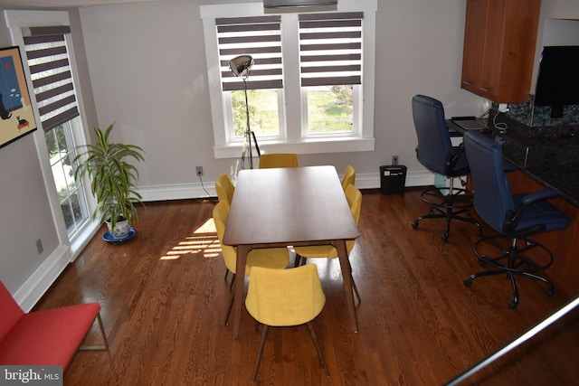 office with wood finished floors, baseboard heating, and baseboards