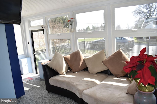 sunroom / solarium with carpet floors and plenty of natural light