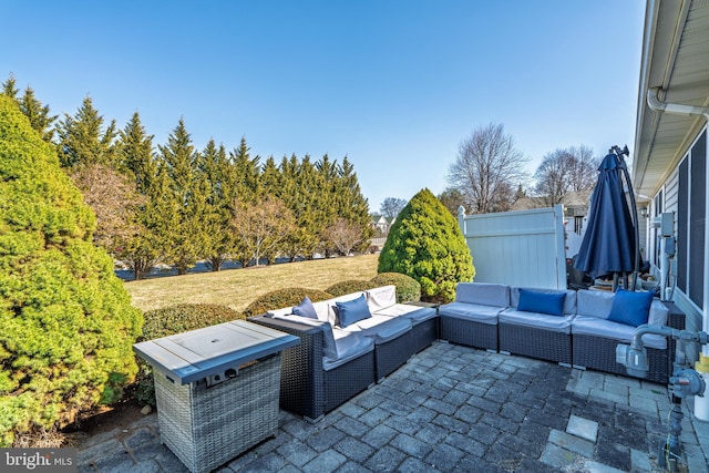 view of patio with an outdoor living space and fence