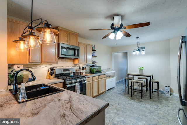 kitchen with a sink, stainless steel appliances, tasteful backsplash, and light brown cabinetry