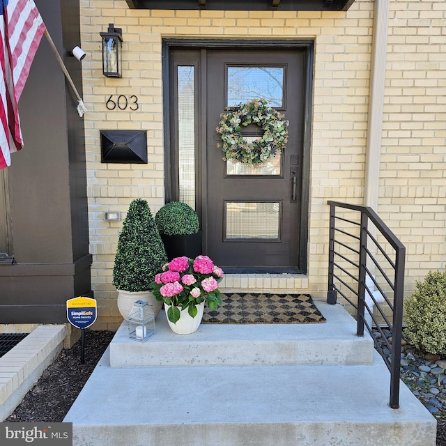 property entrance with brick siding