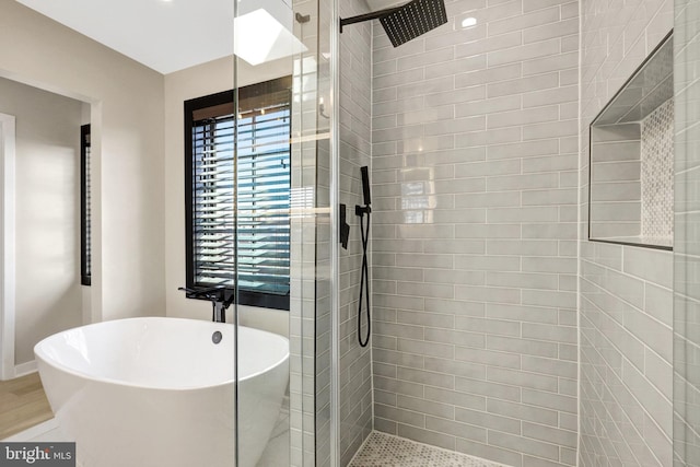 bathroom with a freestanding bath and a shower stall