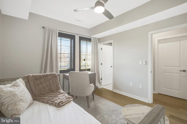 living area featuring a ceiling fan, wood finished floors, and baseboards