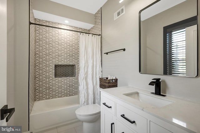 bathroom with vanity, visible vents, shower / bath combination with curtain, tile patterned floors, and toilet