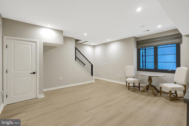 unfurnished room with recessed lighting, light wood-type flooring, visible vents, and stairs