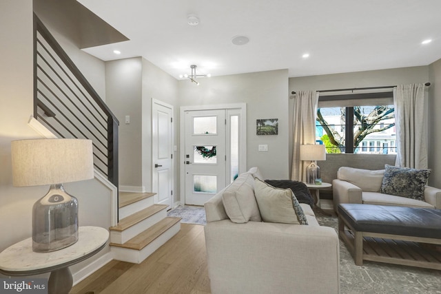 living room featuring recessed lighting, stairway, and wood finished floors