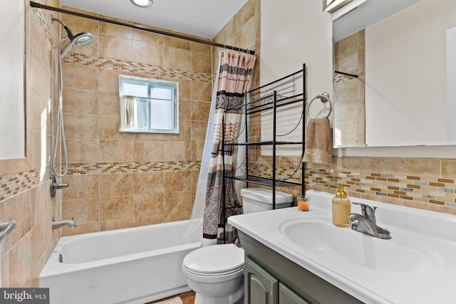 full bathroom featuring tile walls, vanity, toilet, and shower / tub combo