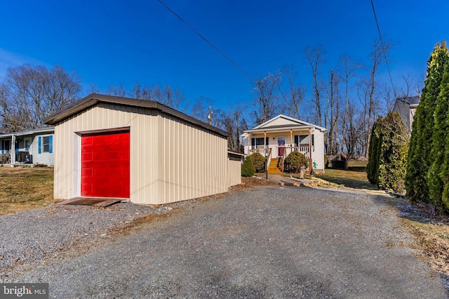 view of front of property with a porch and an outdoor structure