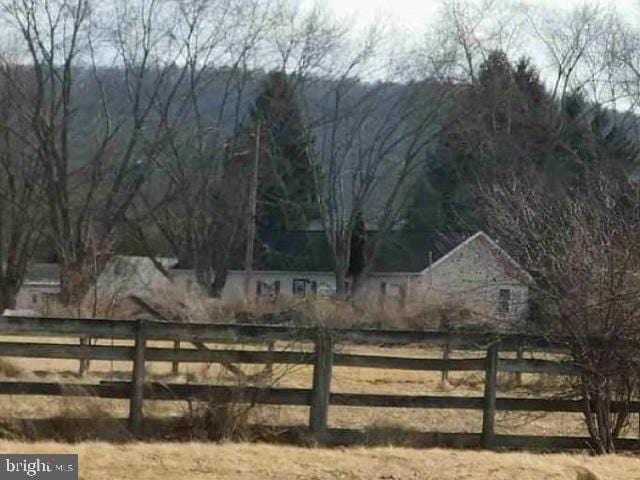 view of yard featuring a rural view and fence