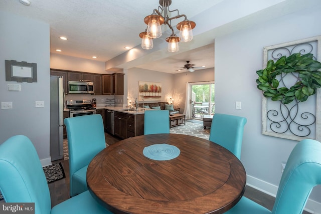 dining area featuring ceiling fan with notable chandelier, recessed lighting, and baseboards