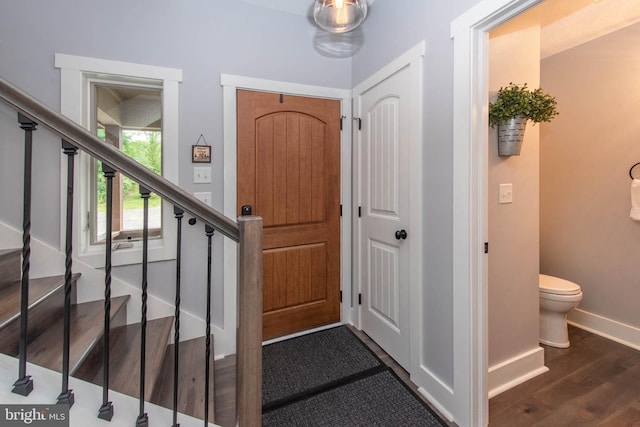 entryway featuring stairs, wood finished floors, and baseboards