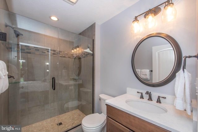 full bath featuring a shower stall, toilet, and vanity