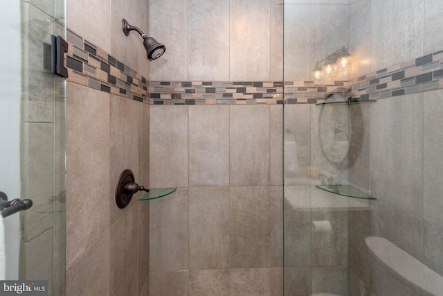 details featuring a tile shower and toilet