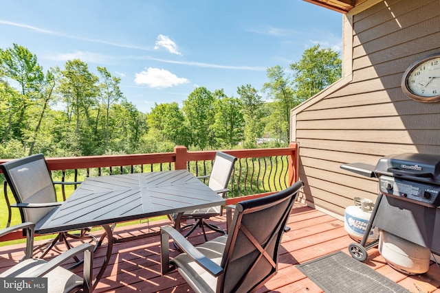 wooden terrace with area for grilling and outdoor dining area