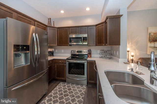 kitchen featuring a sink, stainless steel appliances, and light countertops