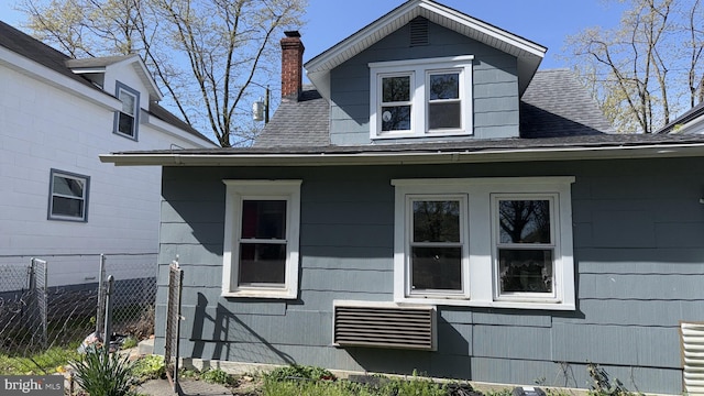 28 Harding Ave, Pennsville, NJ 08070 - view of side of property with a chimney, fence, and a shingled roof