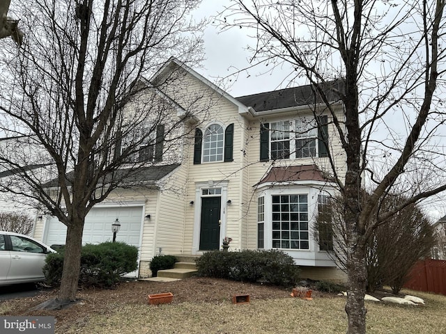 view of front facade with fence and a garage