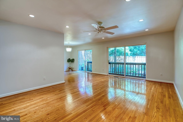 spare room featuring recessed lighting, baseboards, and light wood finished floors