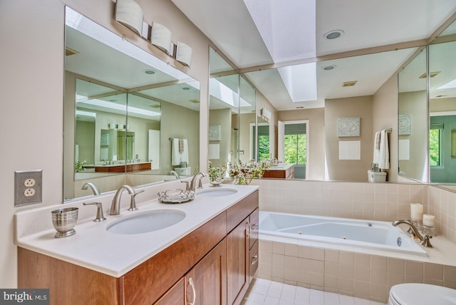 bathroom featuring a sink, visible vents, a jetted tub, and tile patterned flooring