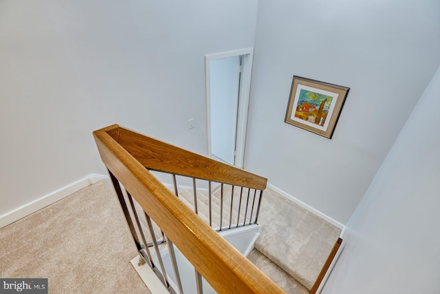 stairs featuring carpet flooring and baseboards