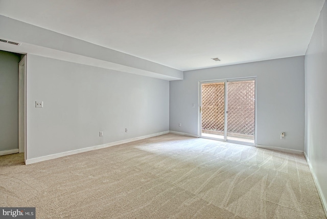 unfurnished room featuring light colored carpet, visible vents, and baseboards