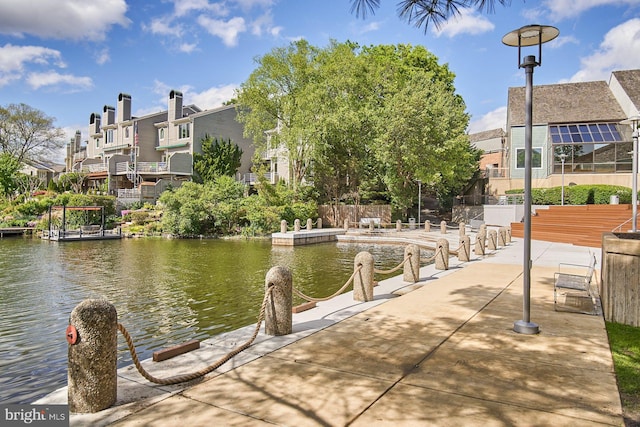 dock area featuring a residential view and a water view