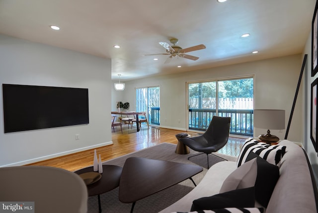 living room featuring recessed lighting, baseboards, light wood-style floors, and a ceiling fan