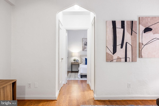 hall featuring wood finished floors and baseboards