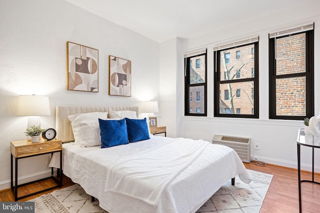 bedroom featuring baseboards and wood finished floors