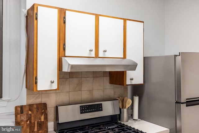 kitchen featuring white cabinetry, range hood, tasteful backsplash, and stainless steel range with gas cooktop