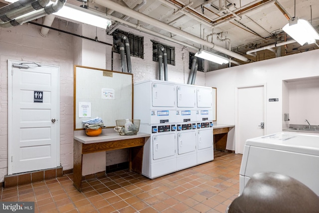 common laundry area with light tile patterned floors, stacked washer / dryer, and washer and dryer