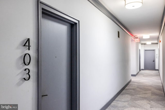 hall featuring visible vents and baseboards